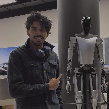 Prateek Pravanjan standing beside a humanoid robot